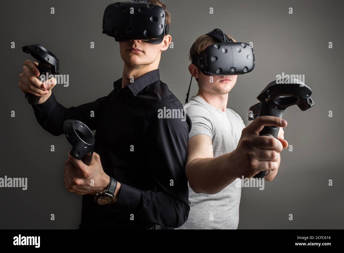 two young man playing game using virtual reality headset Stock Photo