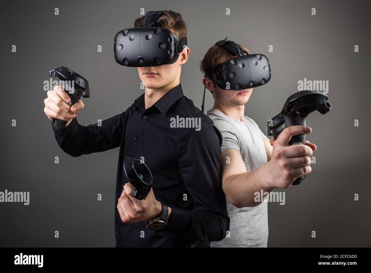 two young man playing game using virtual reality headset Stock Photo ...
