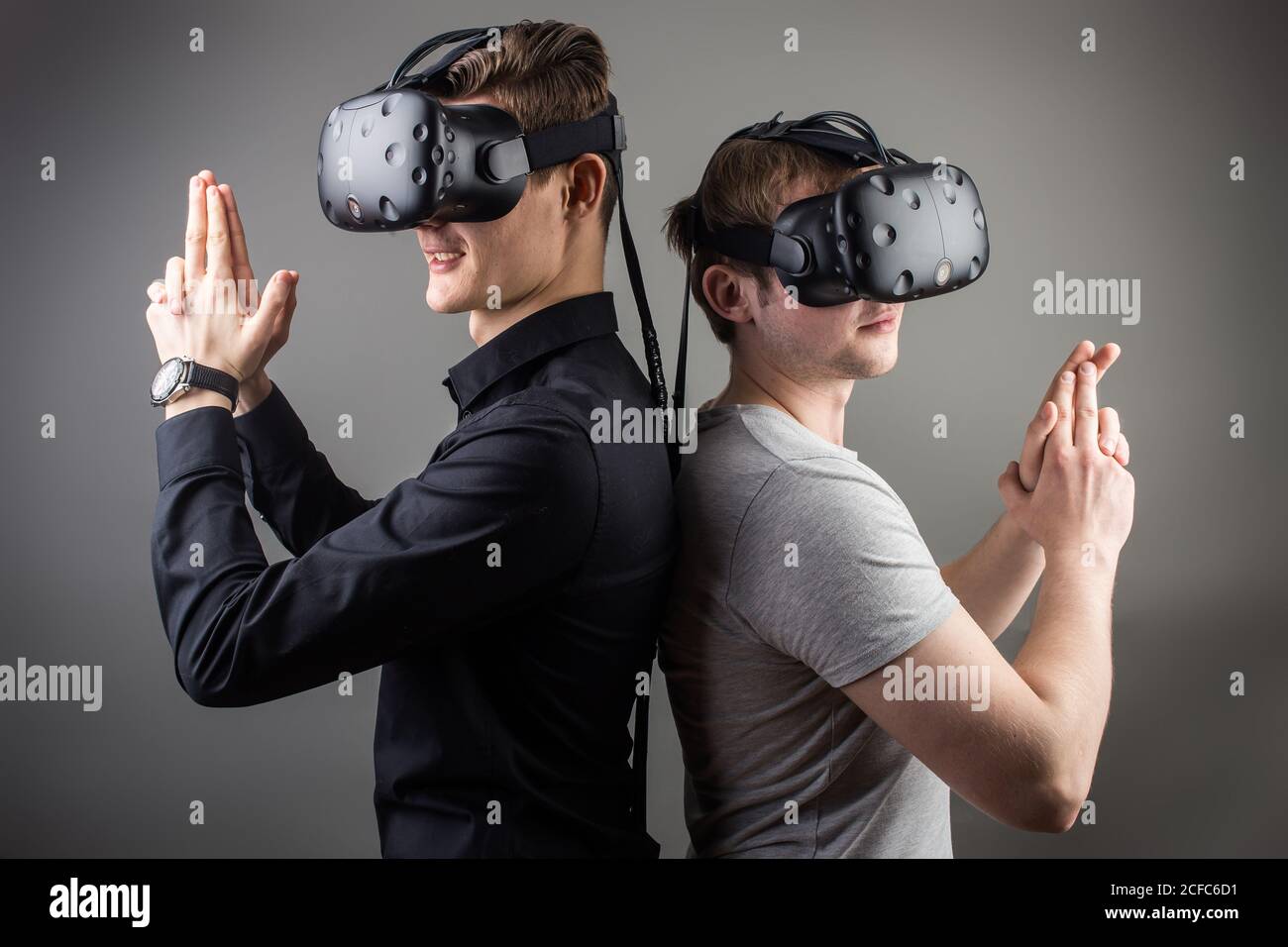 Cheerful friends are watching modern headset Stock Photo