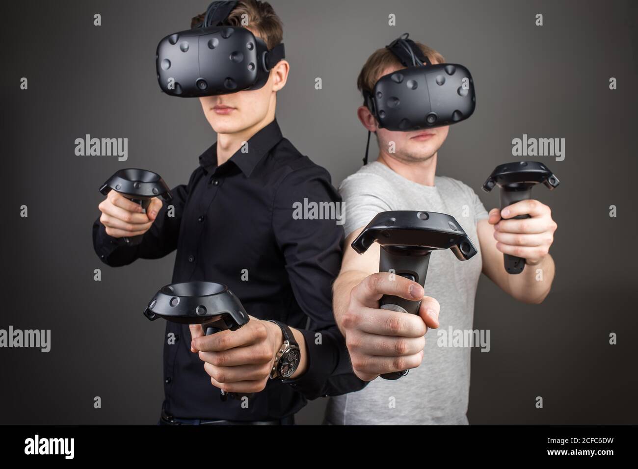 two young man playing game using virtual reality headset Stock Photo ...