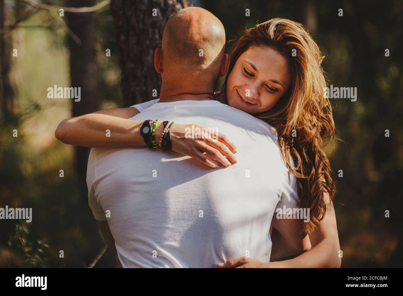 Happy couple embraced in forest Stock Photo