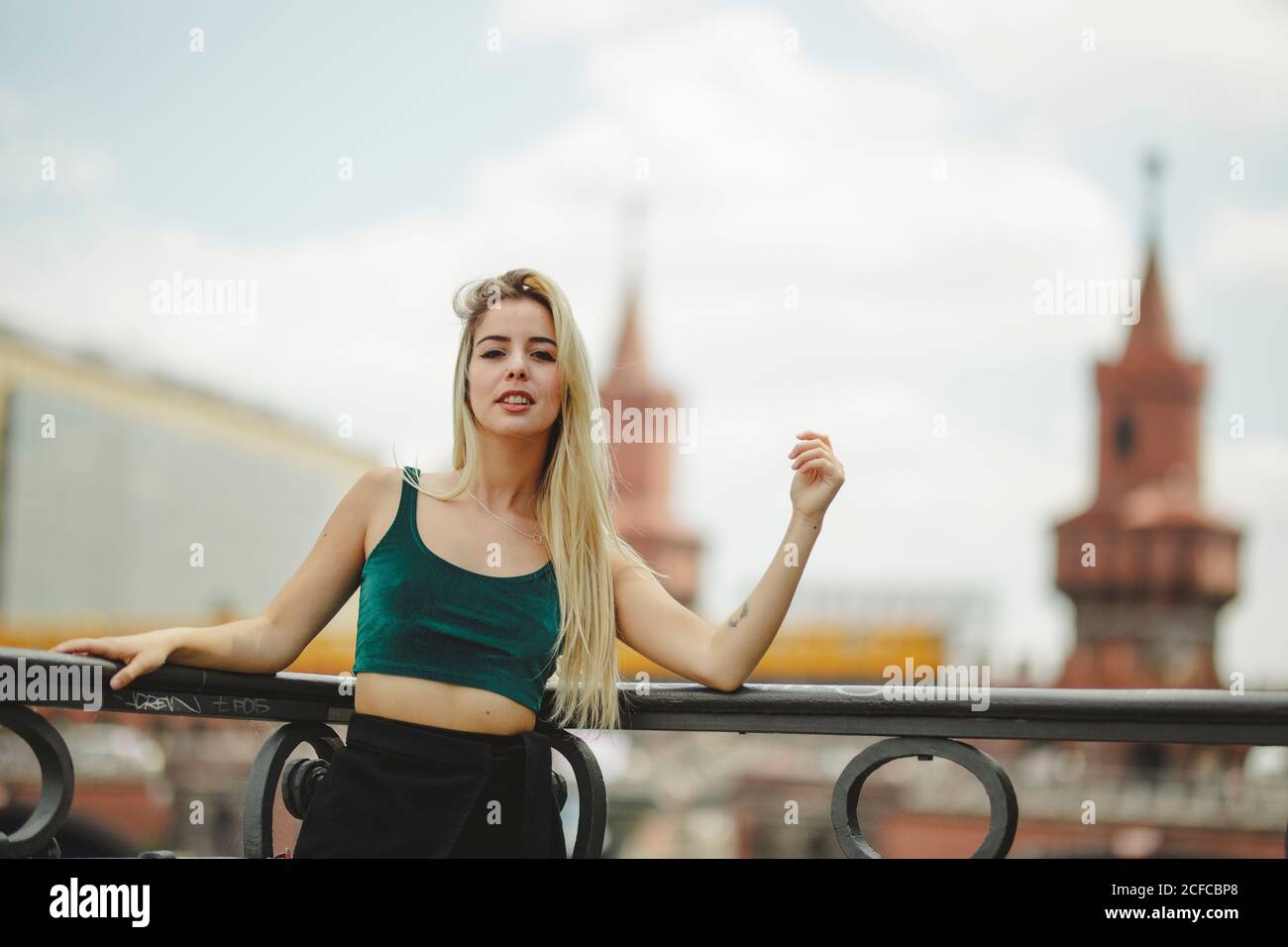 Blond Railing Beautiful blonde female model leaning on railing on summer day in ...