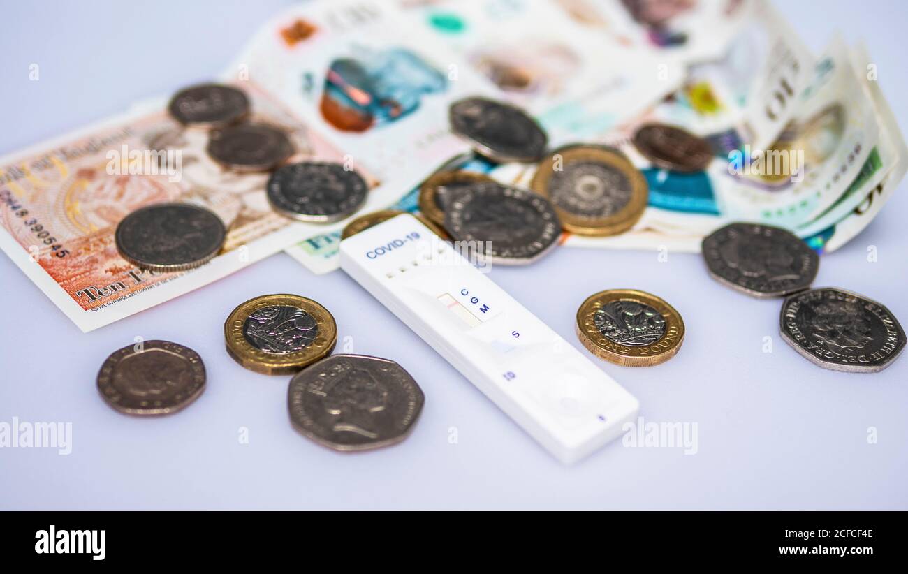 Covid-19 rapid antibody test with a selection of coins Stock Photo