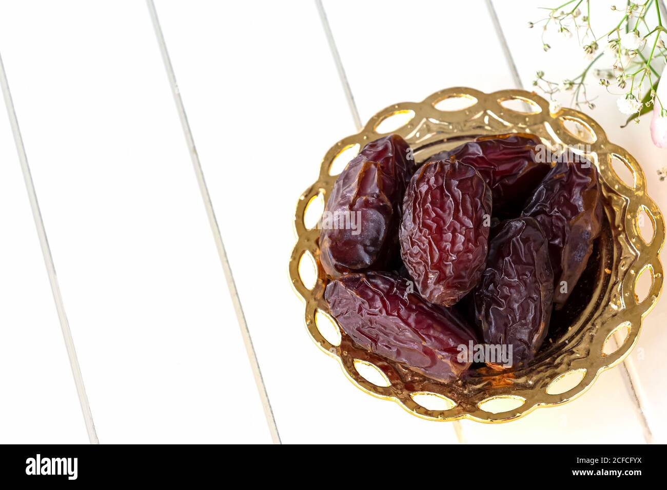 Organic dried dates in traditional arabic golden plate. Holy month