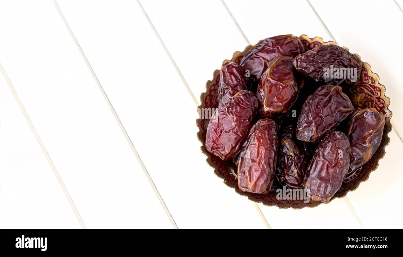Organic dried dates in traditional arabic plate. Holy month Ramadan