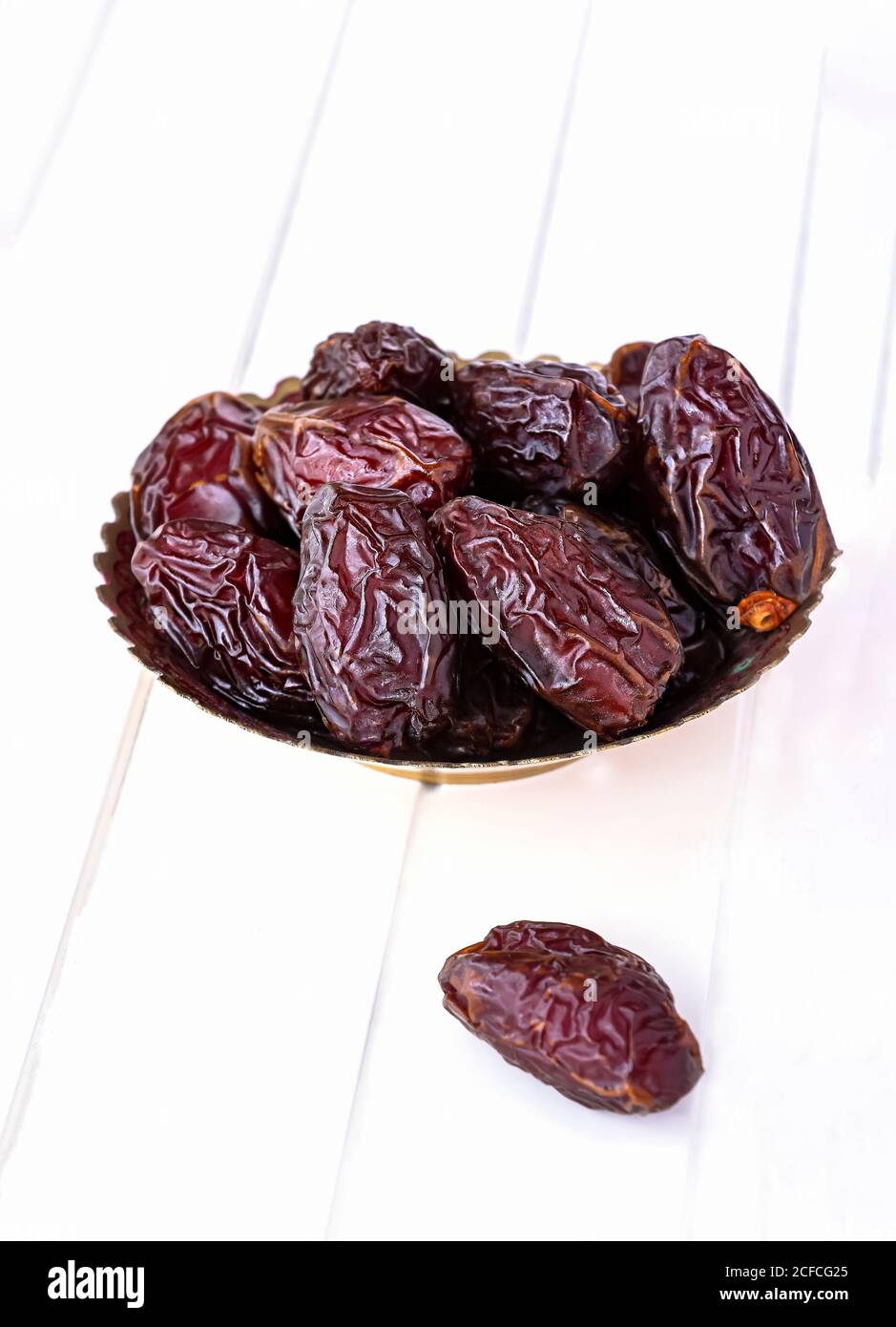Organic dried dates in traditional arabic golden plate. Holy month