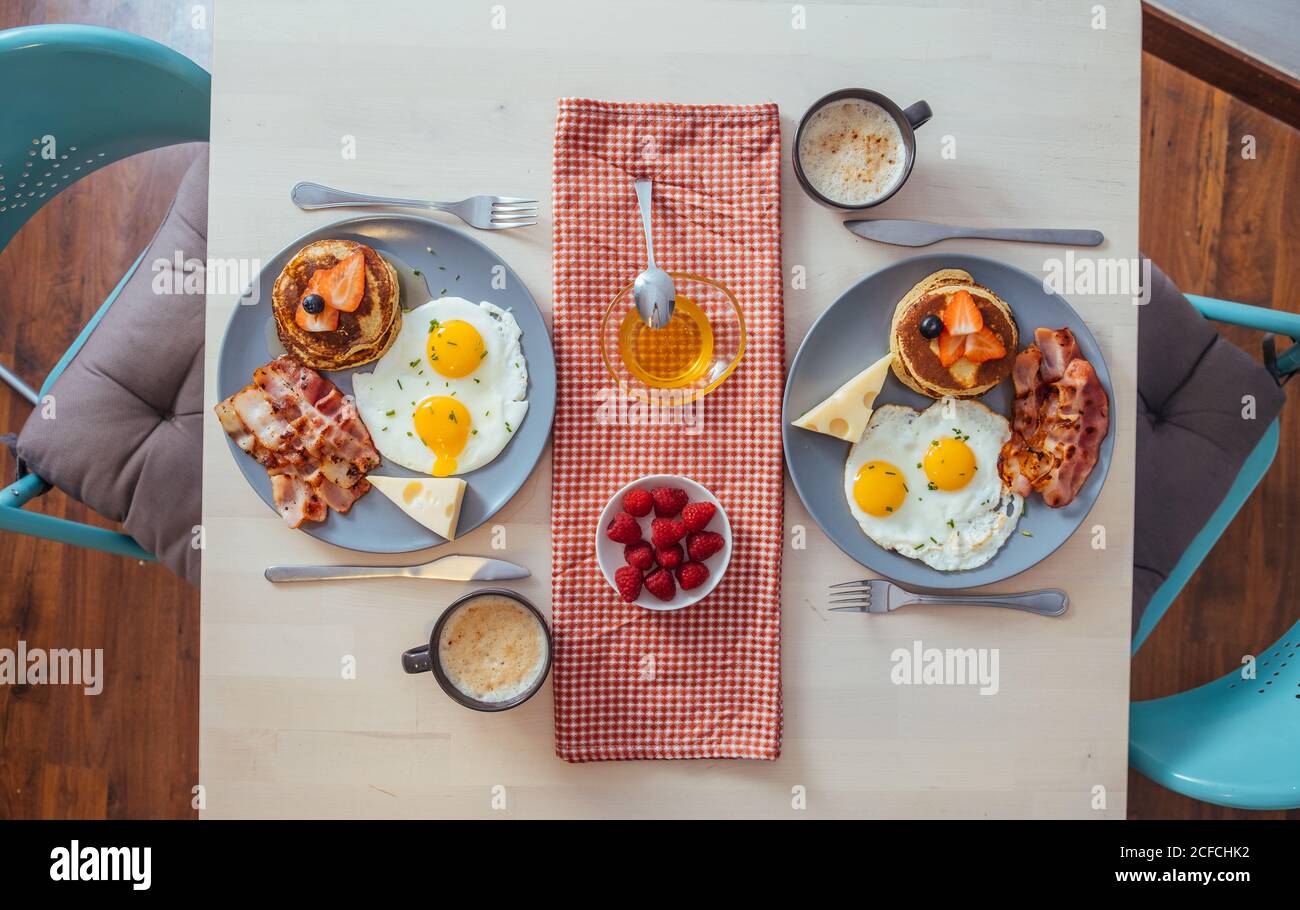 Delicious fried eggs with bacon and cheese for breakfast Stock Photo