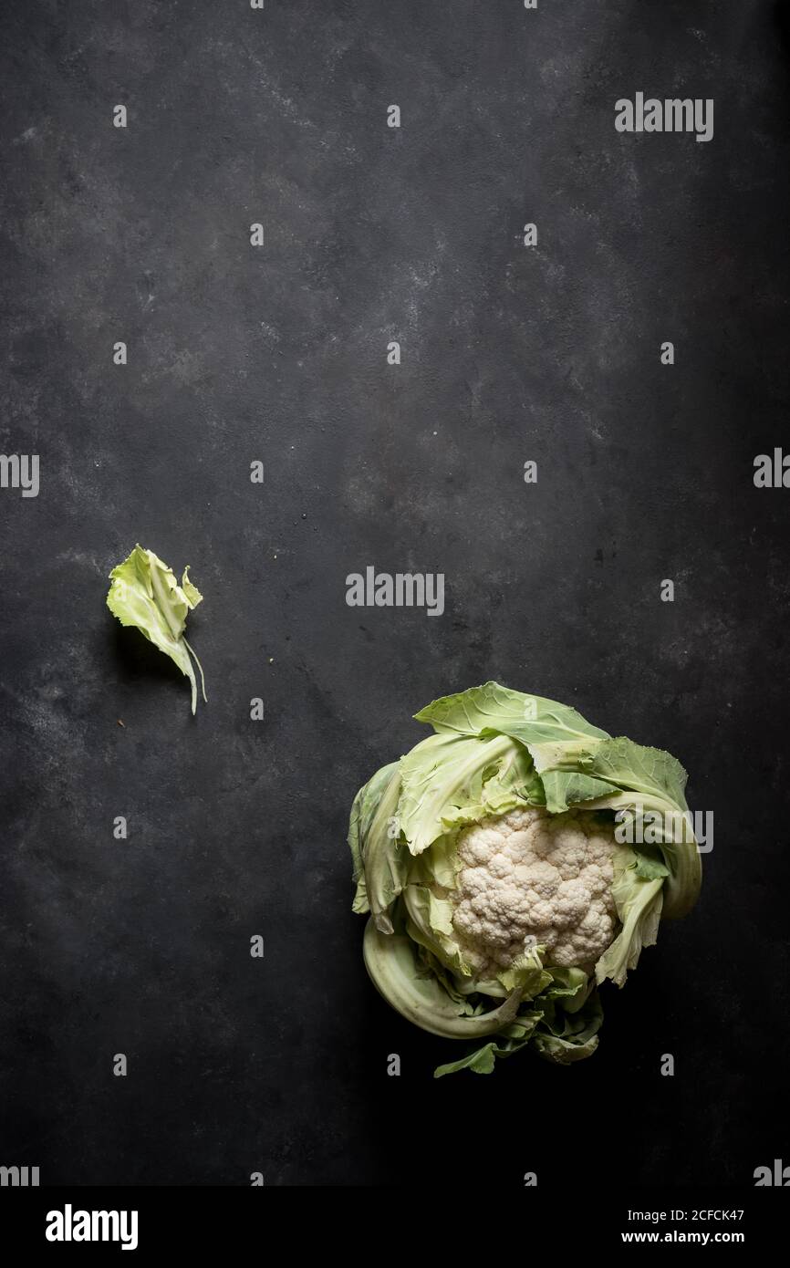 From above fresh green cauliflower head on grey background Stock Photo