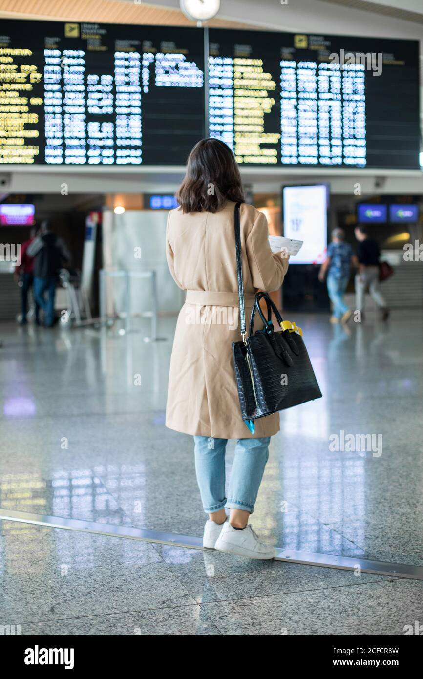 Woman standing in airport hi-res stock photography and images - Alamy