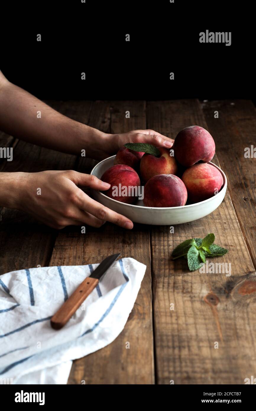 Tasty ripe peaches in plate Stock Photo