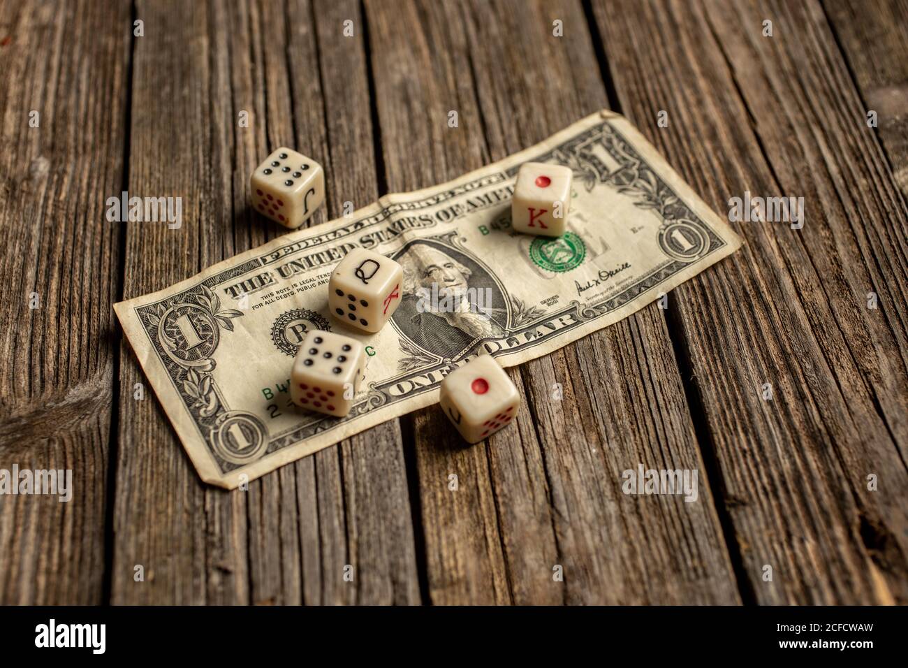 Playing dice on dollar bill Stock Photo Alamy