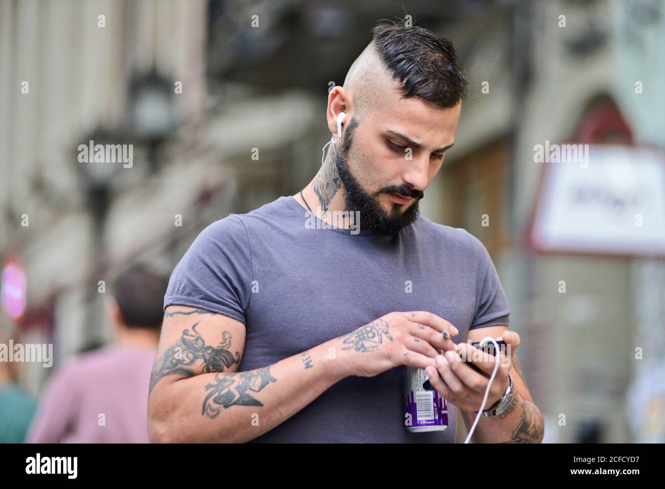 Tattooed Georgian man walking in Shota Rustaveli Avenue, Tbilisi, Georgia Stock Photo