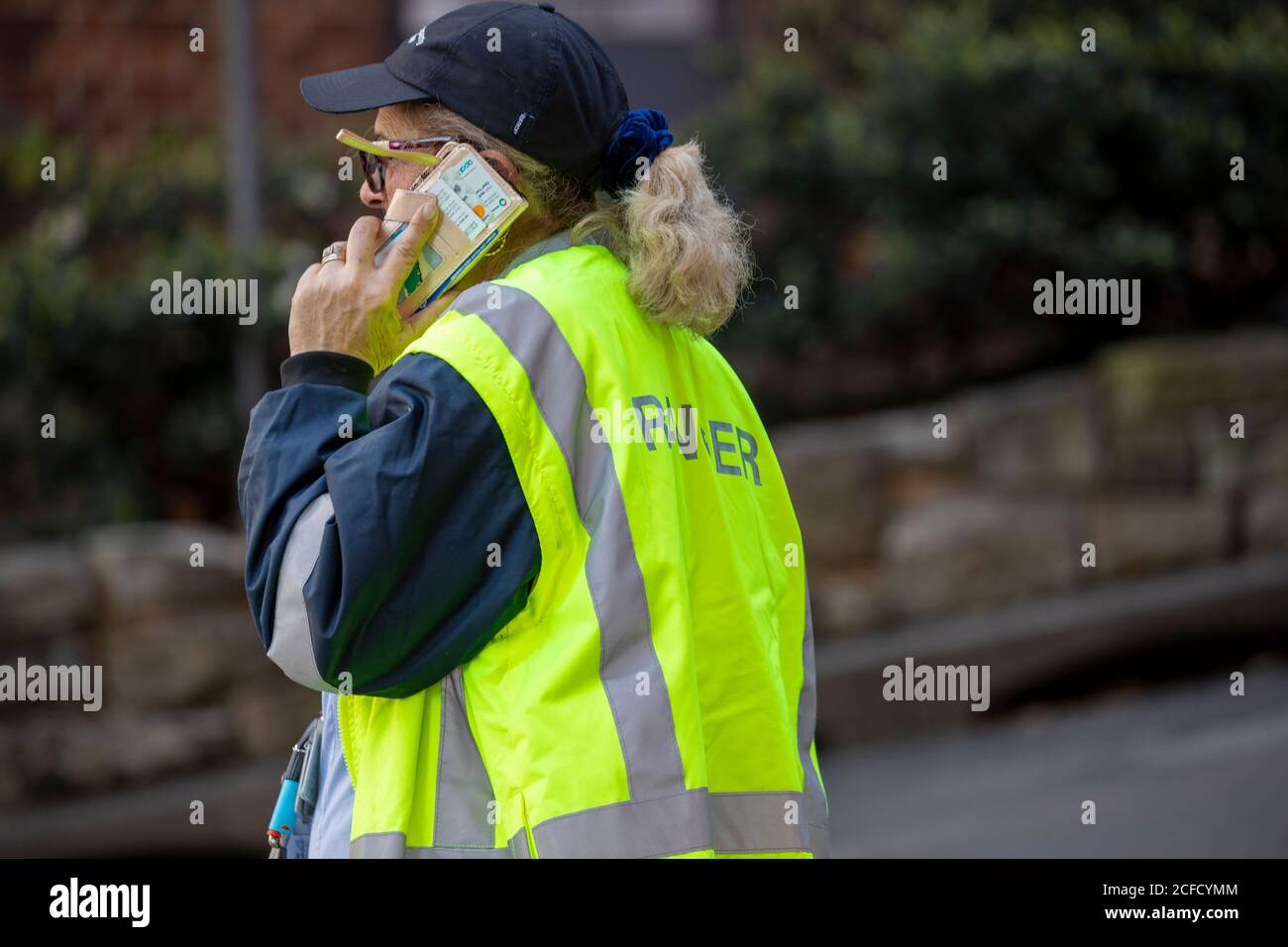 Sydney council ranger talking on her mobile phone,Sydney,Australia Stock Photo