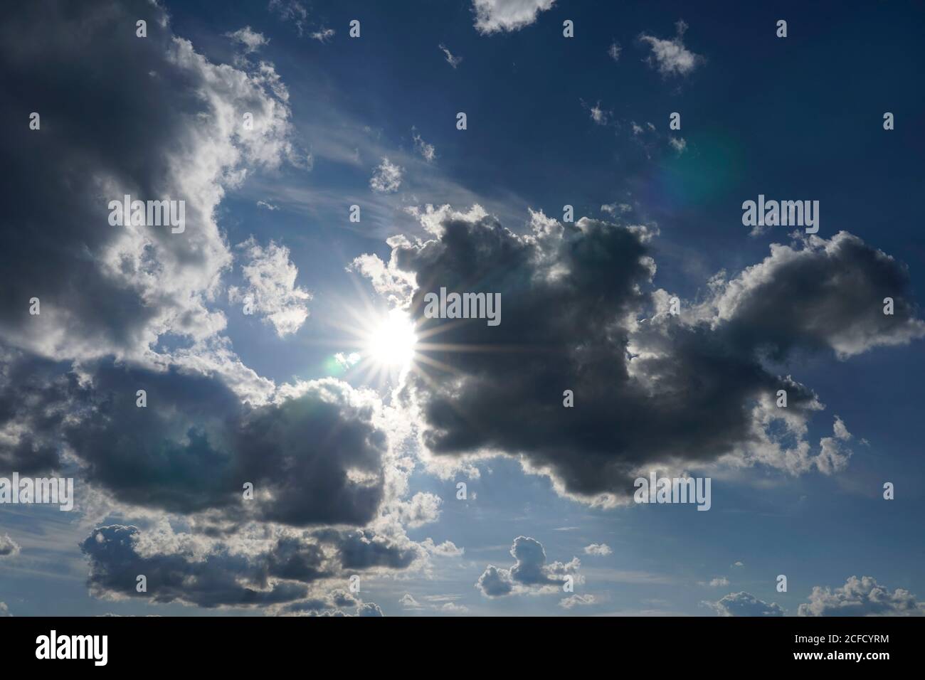 Germany, Bavaria, Upper Bavaria, Altötting District, cloud formation, sun behind dark rain clouds, Nimbostratus Stock Photo