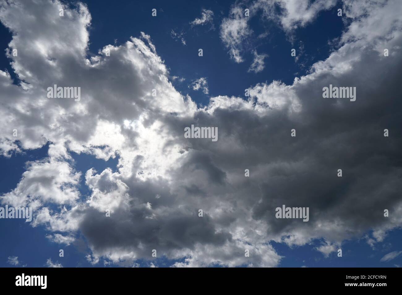 Germany, Bavaria, Upper Bavaria, Altötting district, cloud formation, sun behind rain clouds, Nimbostratus, blue sky Stock Photo