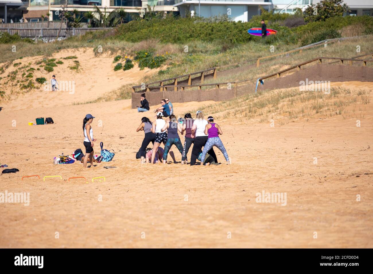 Group of australian women exercising on a Sydney beach with personal