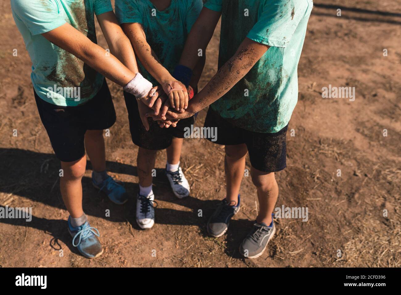 Mid section of group of boys stacking their hands together Stock Photo ...