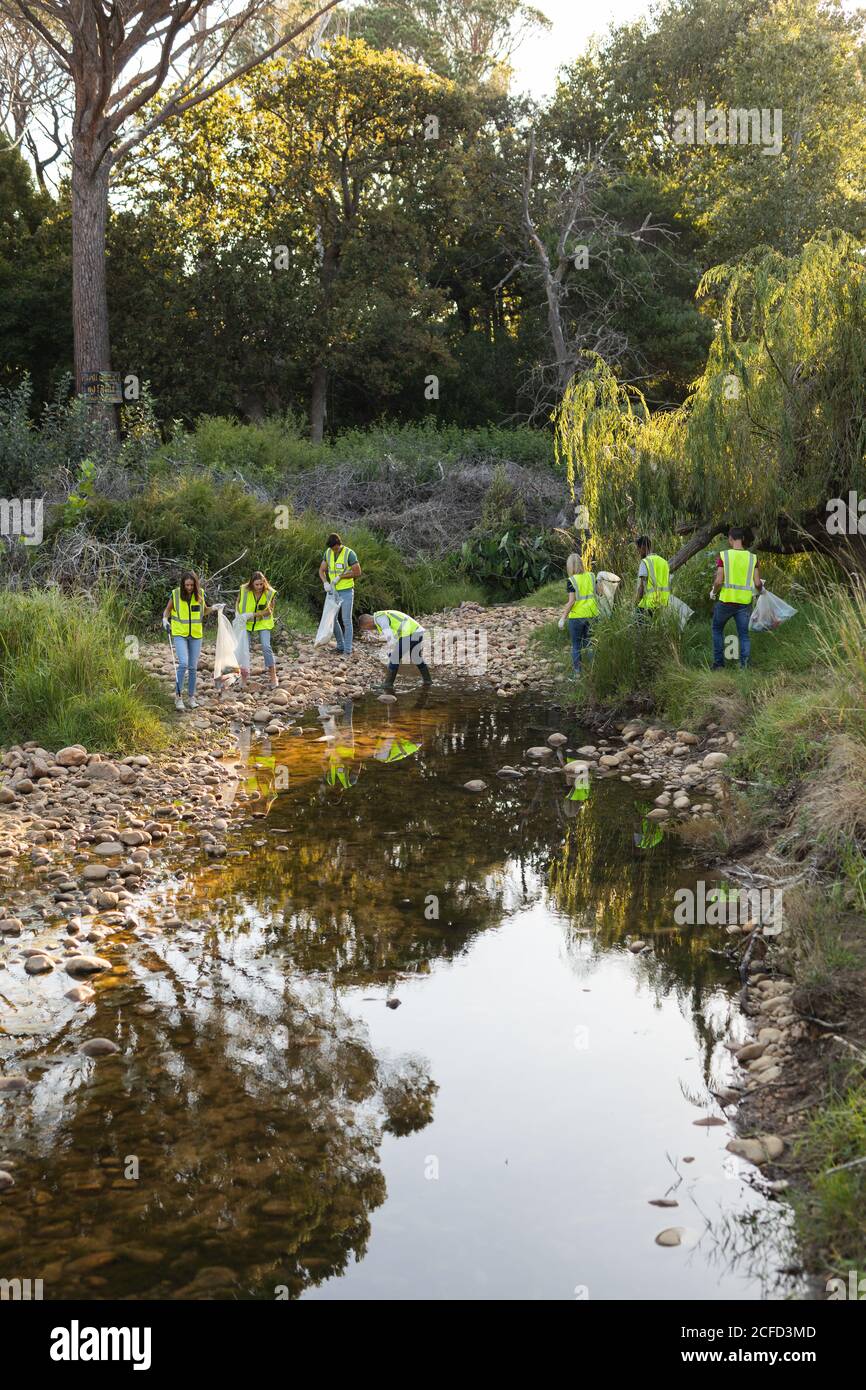 Group of conservation volunteers cleaning up river in the countryside Stock Photo