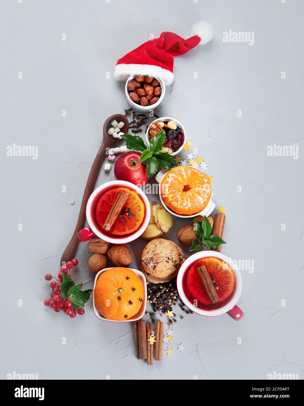 Christmas Tree made of holiday food on concrete background. Top view, flat lay. Christmas concept. New Year Holidays background. Stock Photo