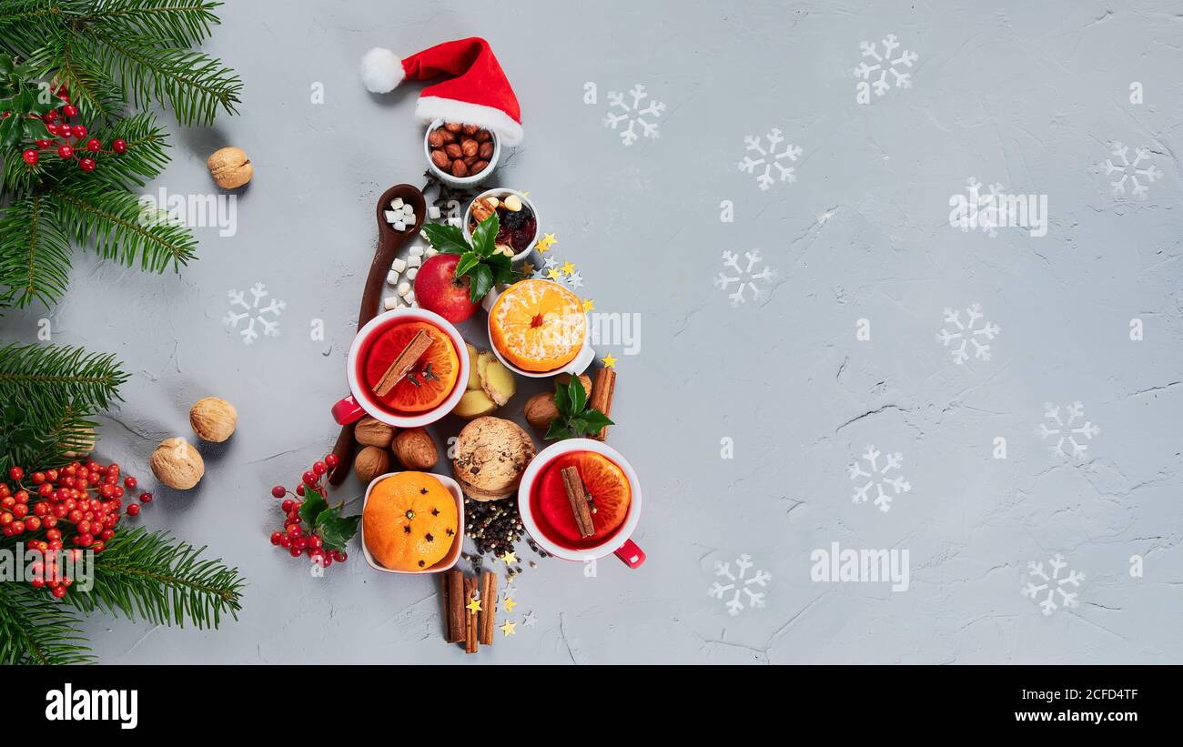 Christmas Tree made of holiday food on concrete background. Top view, flat lay  with copy space. Christmas concept. New Year Holidays background. Stock Photo