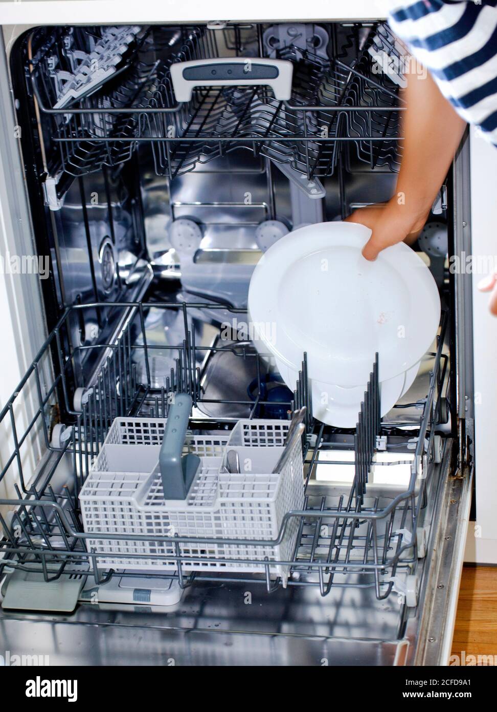 a plate is placed in the dishwasher Stock Photo Alamy
