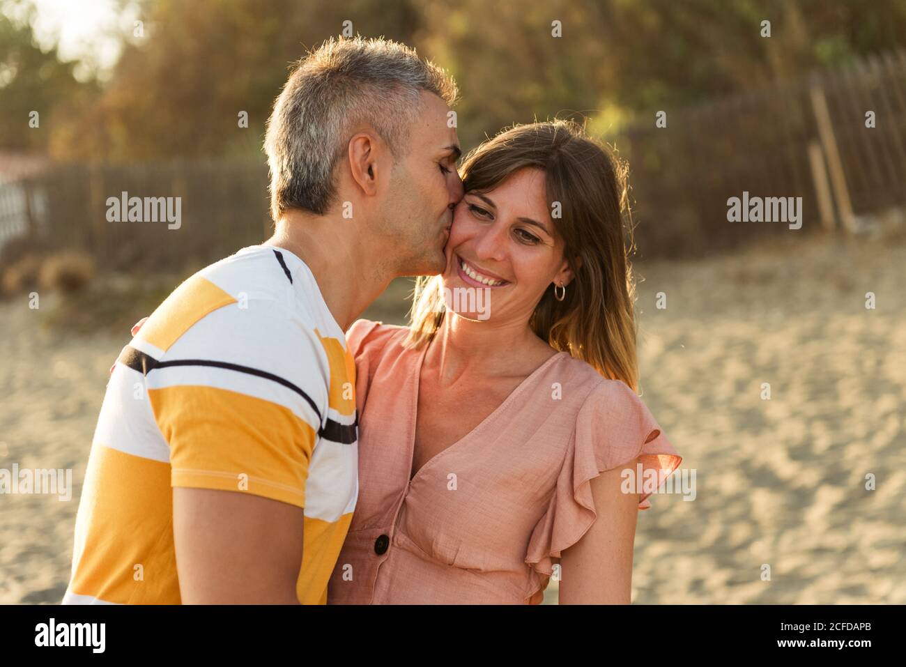 Excited adult man and Woman laughing and embracing each other while ...