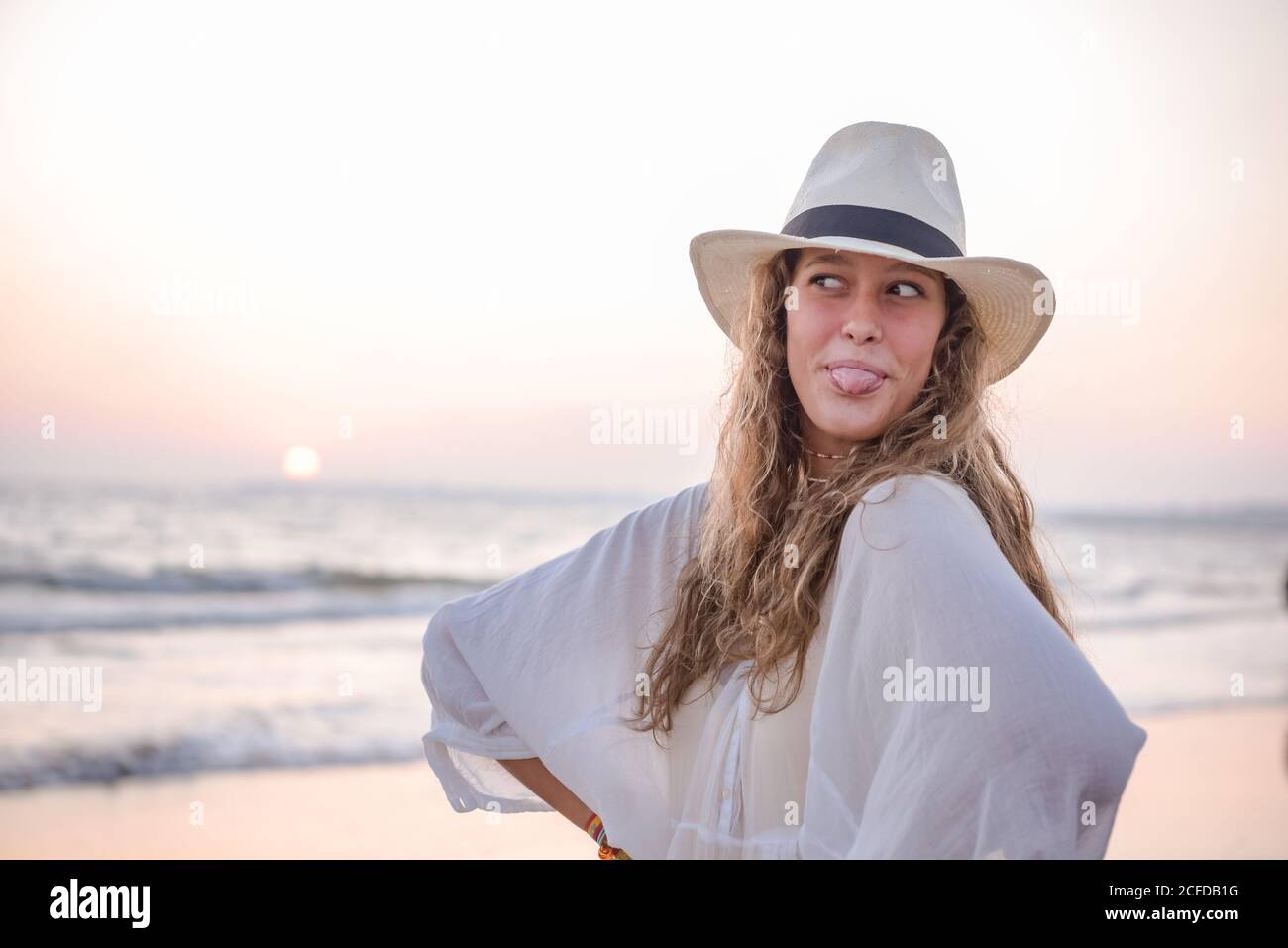 Charming Woman in light white dress on wavy beach Stock Photo - Alamy