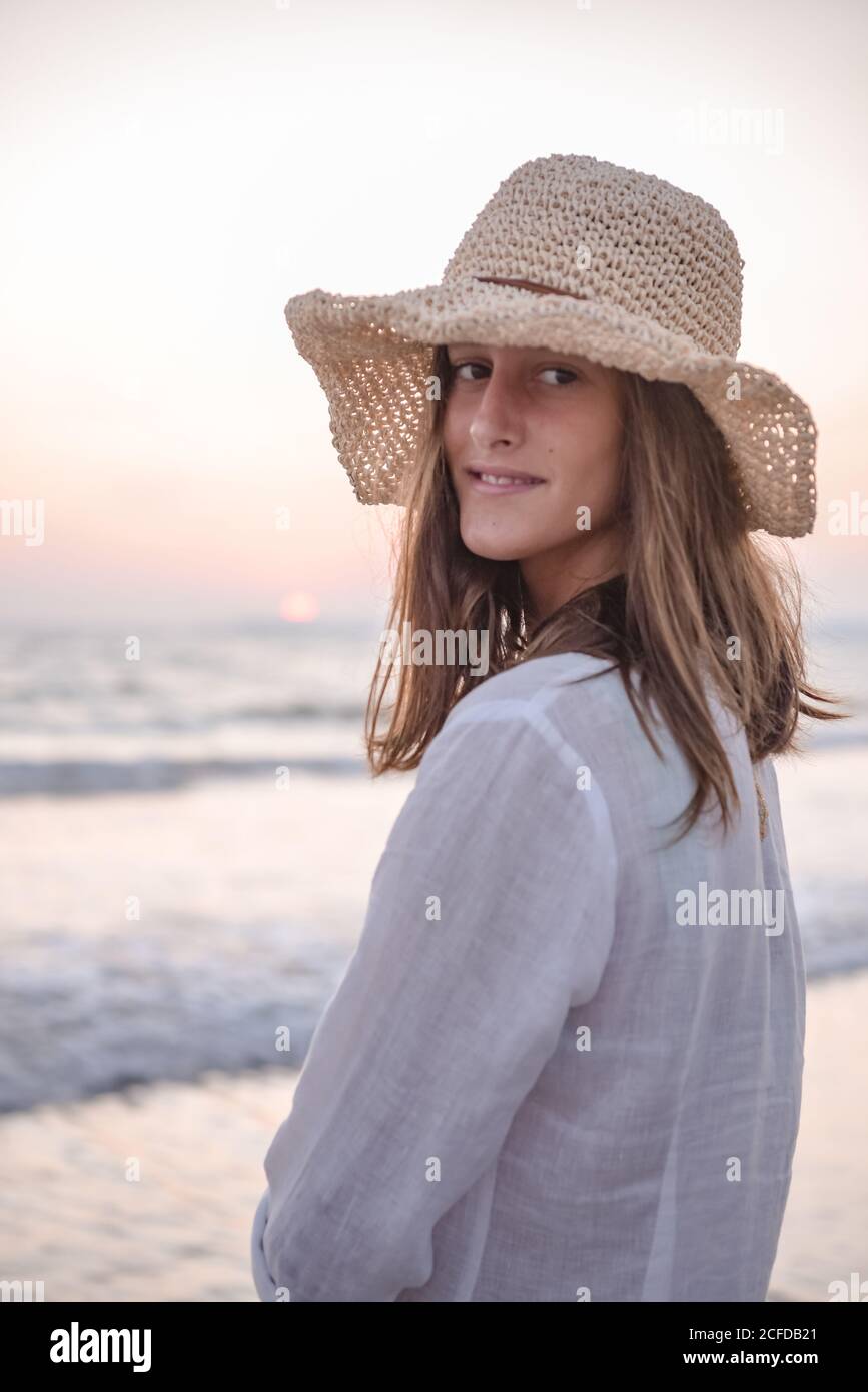 Charming Woman in light white dress on wavy beach Stock Photo - Alamy