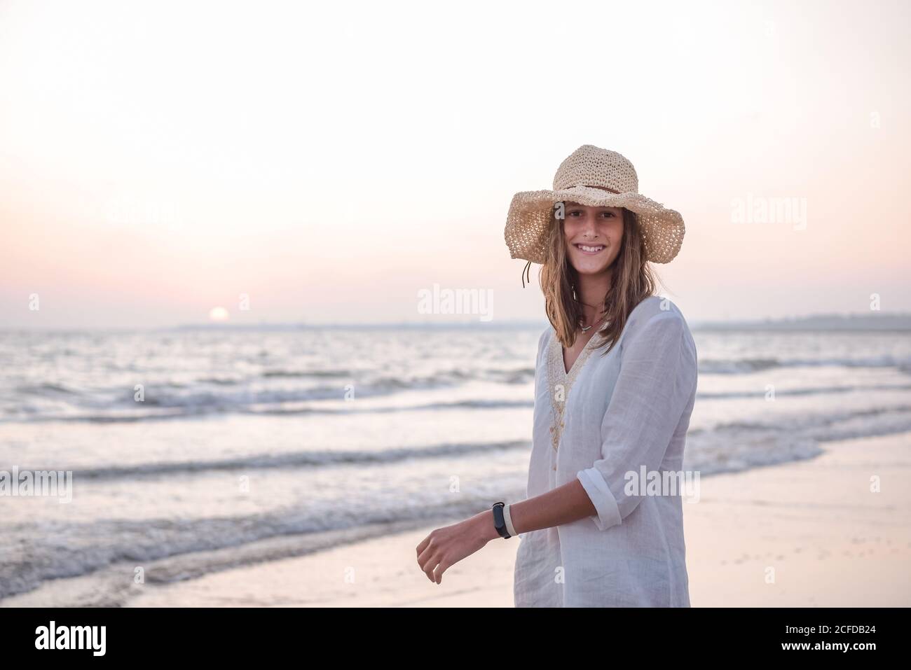 Charming Woman in light white dress on wavy beach Stock Photo - Alamy