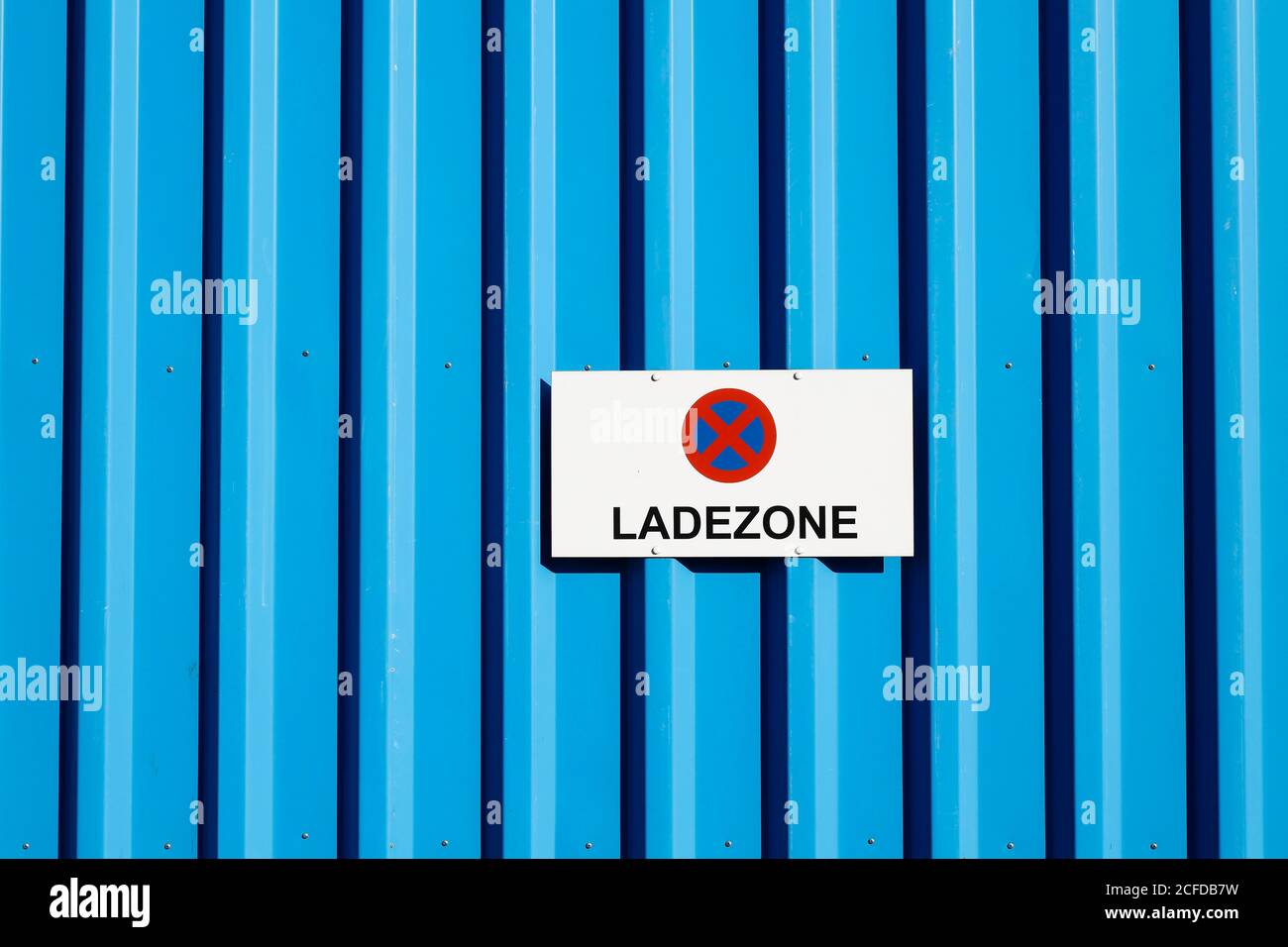 Sign loading area on a blue wall of a commercial hall in the Osthafen, Frankfurt am Main, Hesse, Germany Stock Photo