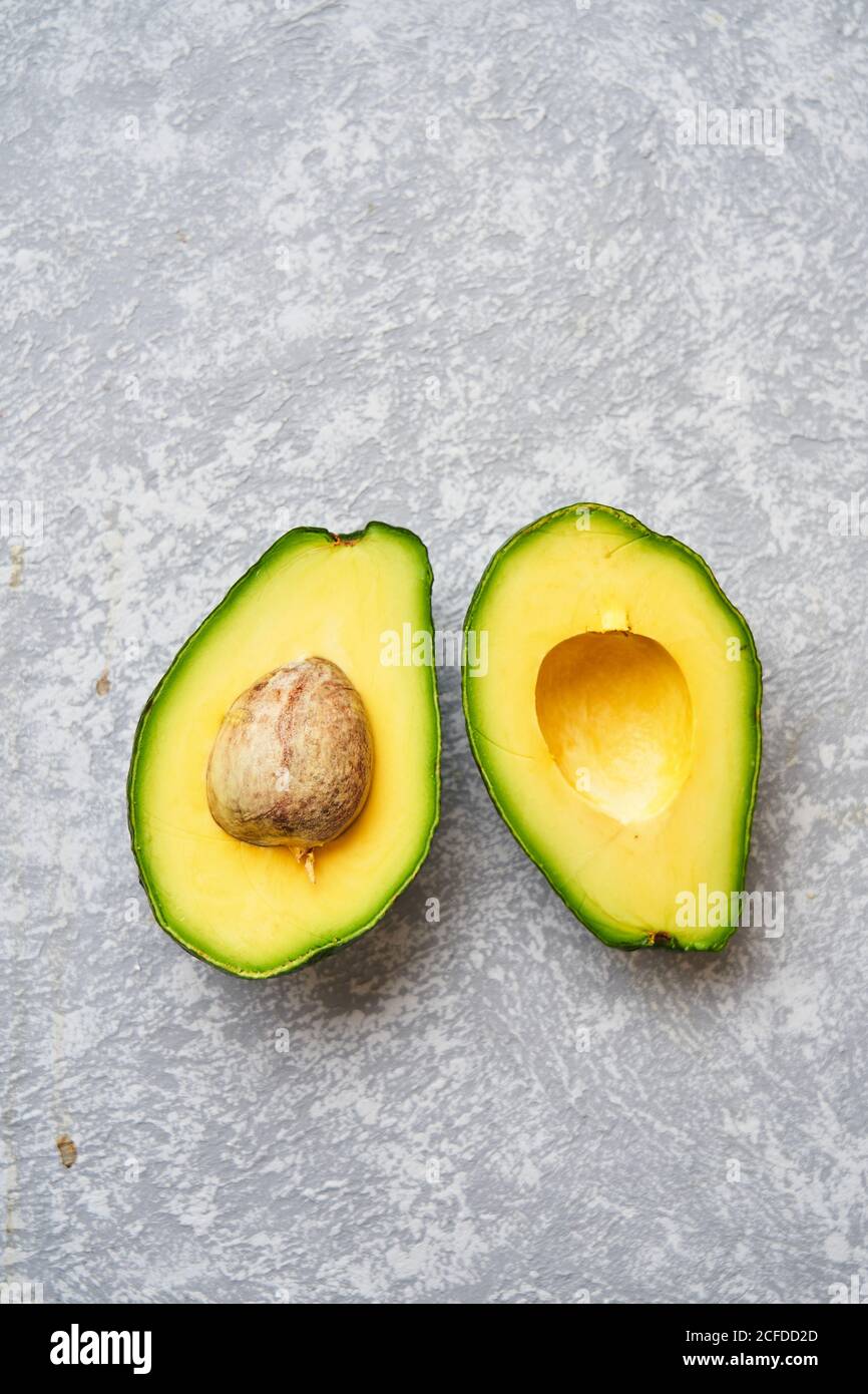 Top View Of Fresh Ripe Avocado Cut In Half On Light Grey Texture Background Stock Photo Alamy