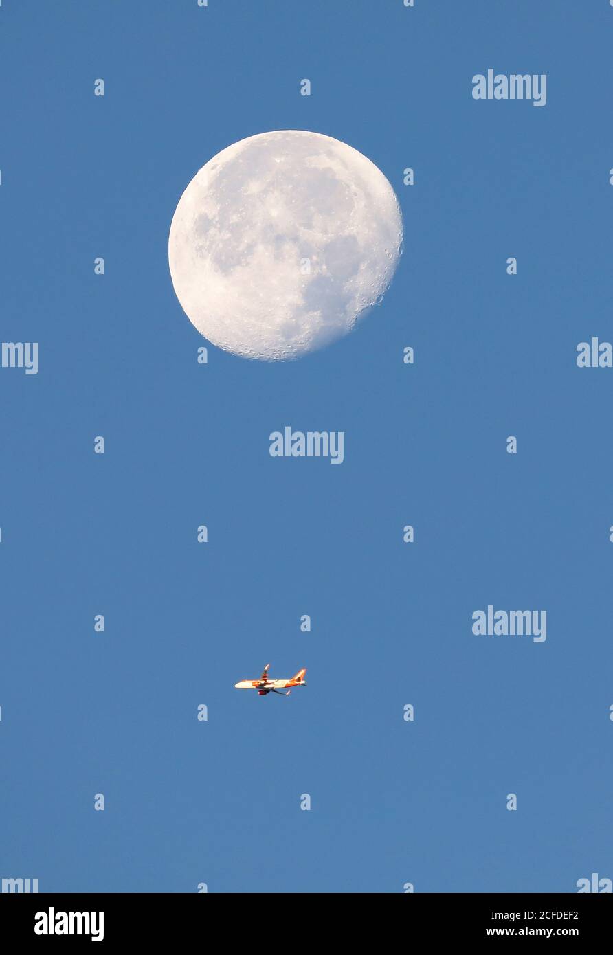 Gatwick, UK. 05th Sep, 2020. A easyJet flight climbs high in the sky beneath the moon after taking off from Gatwick on route to Murcia, Spain. Credit: James Boardman/Alamy Live News Stock Photo