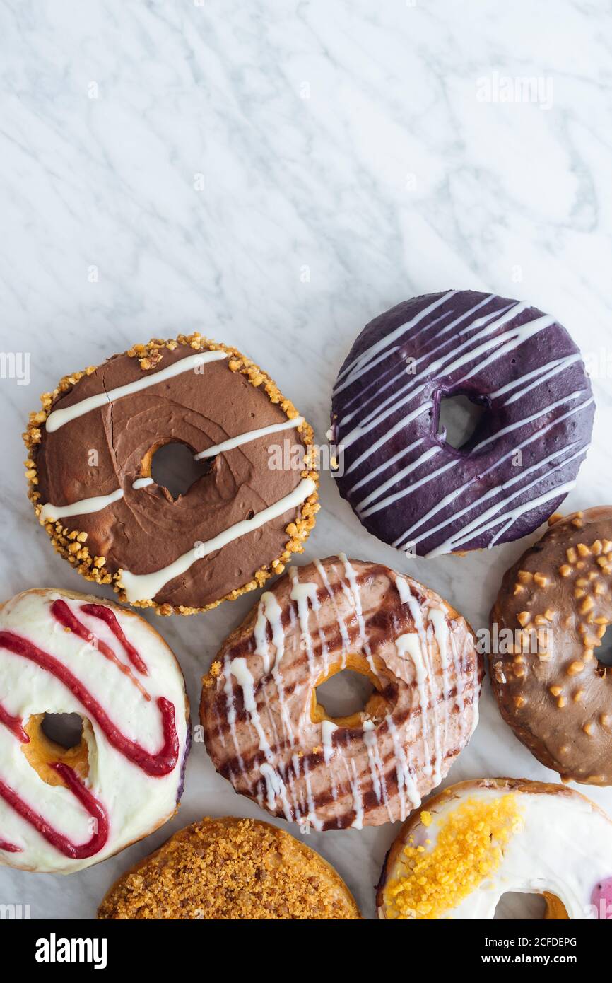 Variety of doughnuts on marble background Stock Photo