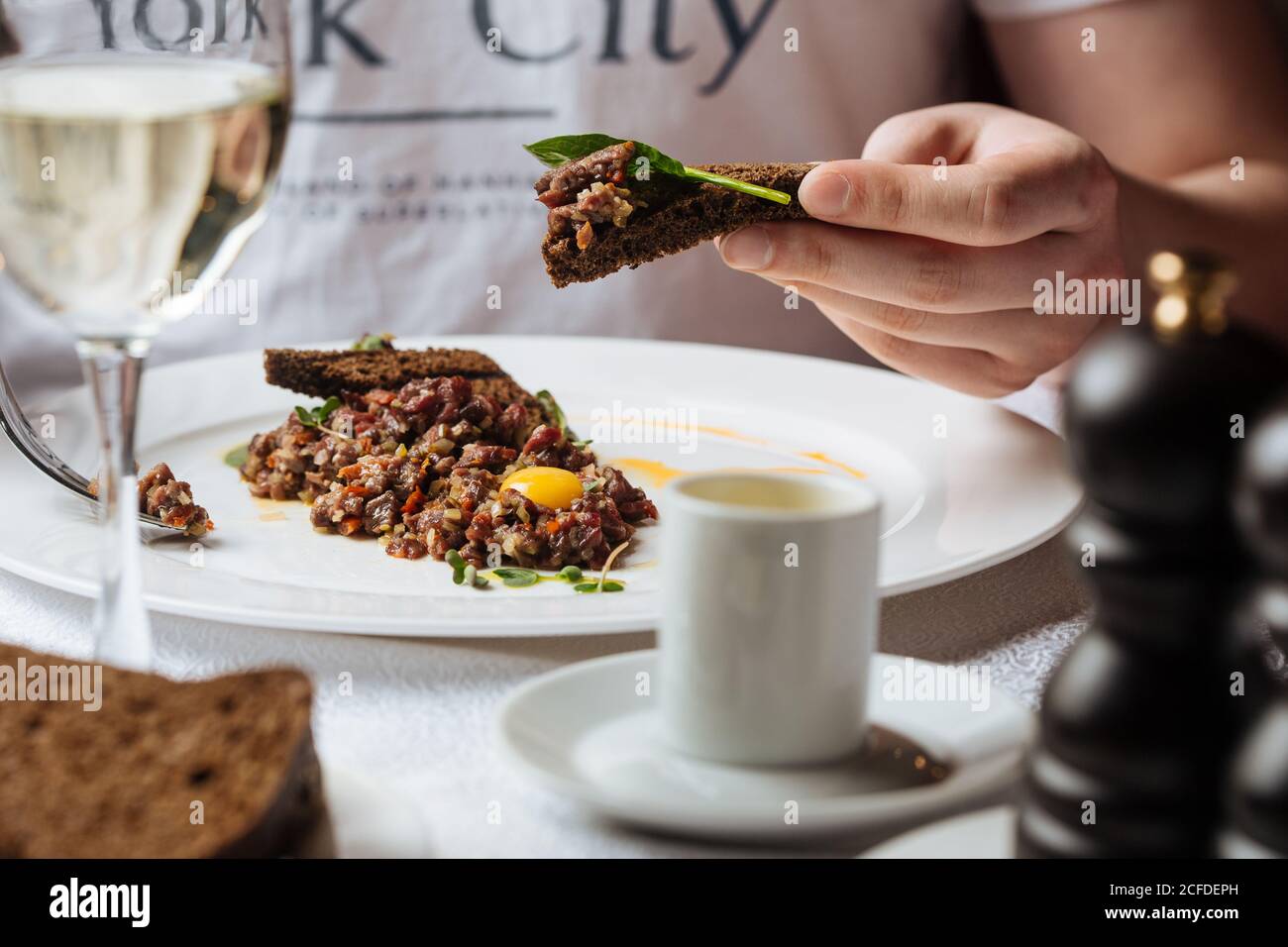 man eating appetizer in restaurant Stock Photo
