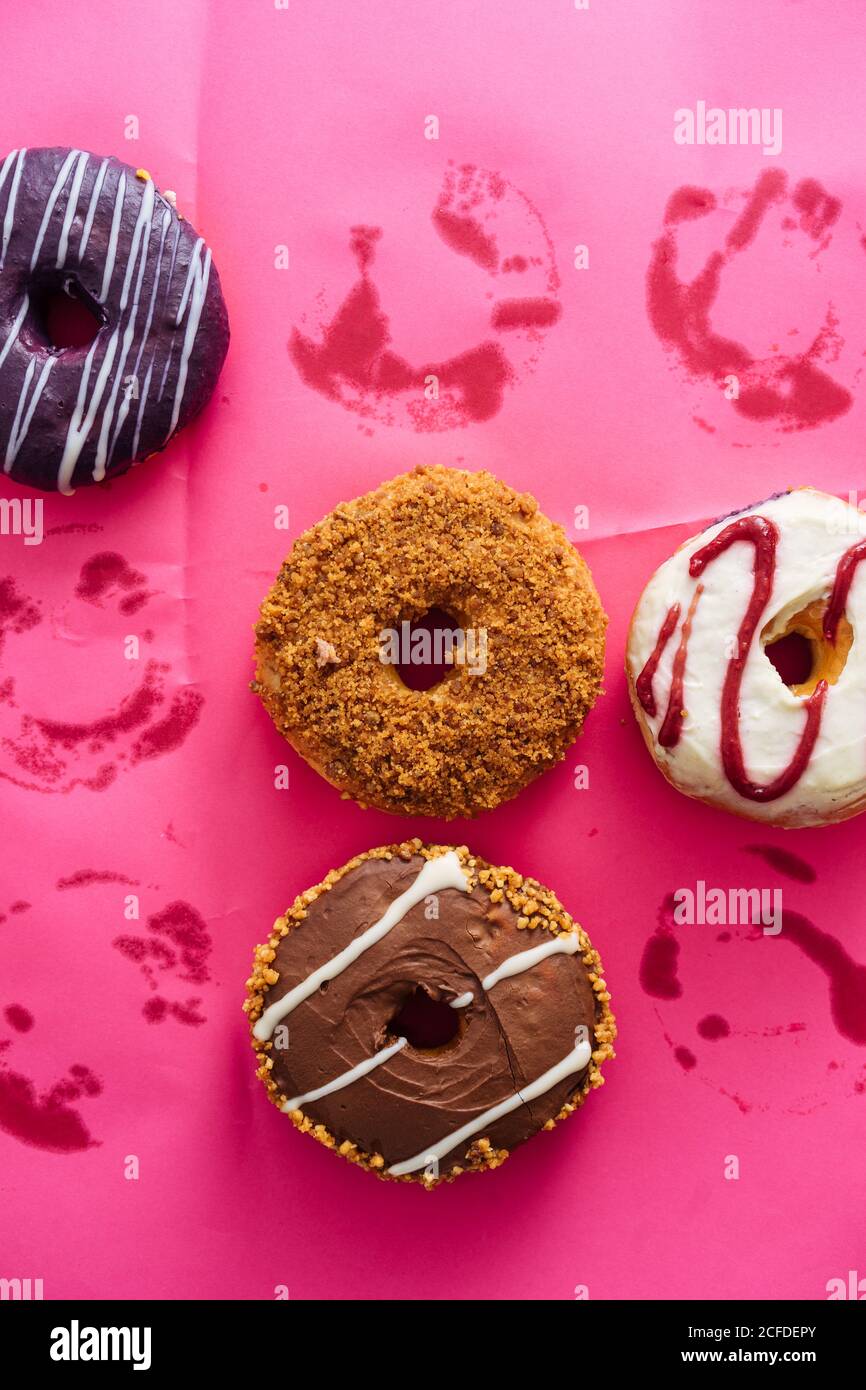 Variety of doughnuts on pink background Stock Photo
