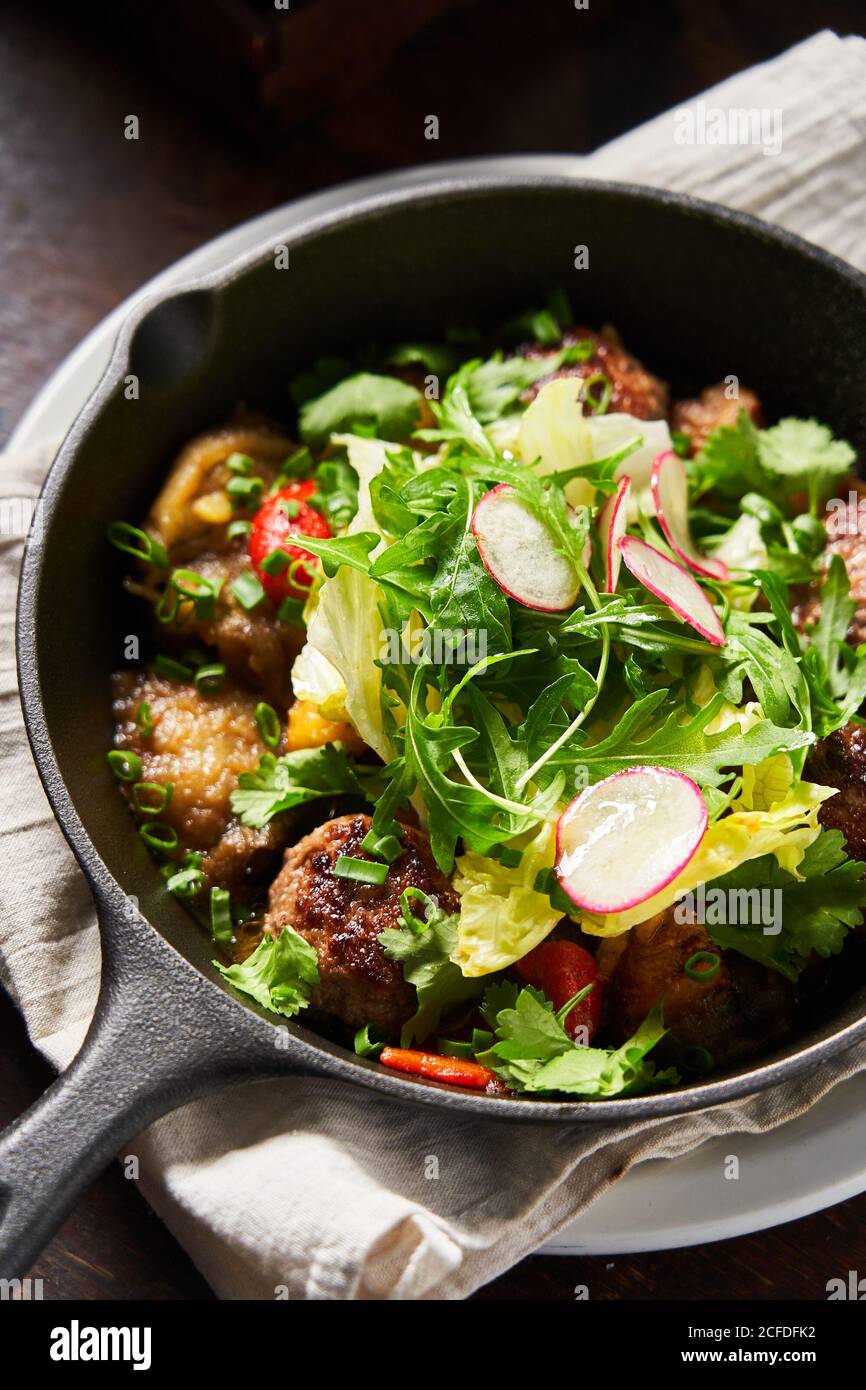 Roasted meatballs and salad in pan Stock Photo