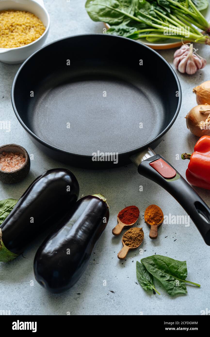 Fresh ingredients around empty frying pan Stock Photo