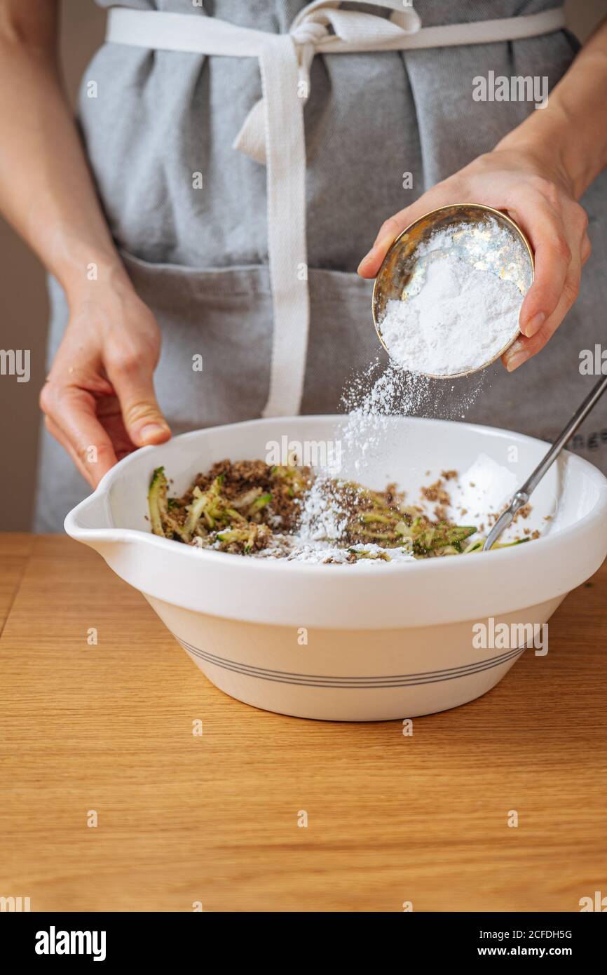 Woman adding salt to food hires stock photography and images Alamy