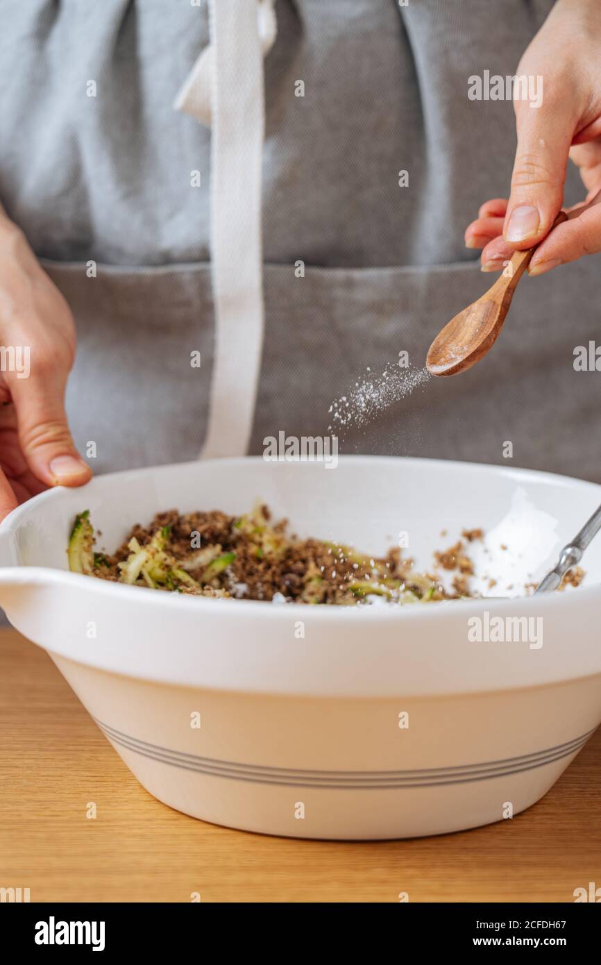 Woman adding salt to food hires stock photography and images Alamy