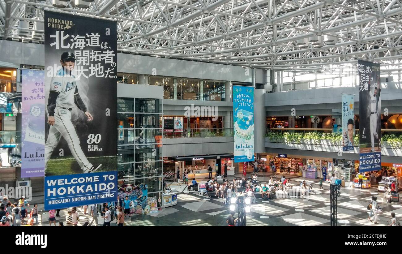 Sapporo, Hokkaido, Japan -  Domestic terminal atrium of New Chitose Airport. Advertising hanging banners about Sapporo Beer and Nippon-Ham Fighters. Stock Photo