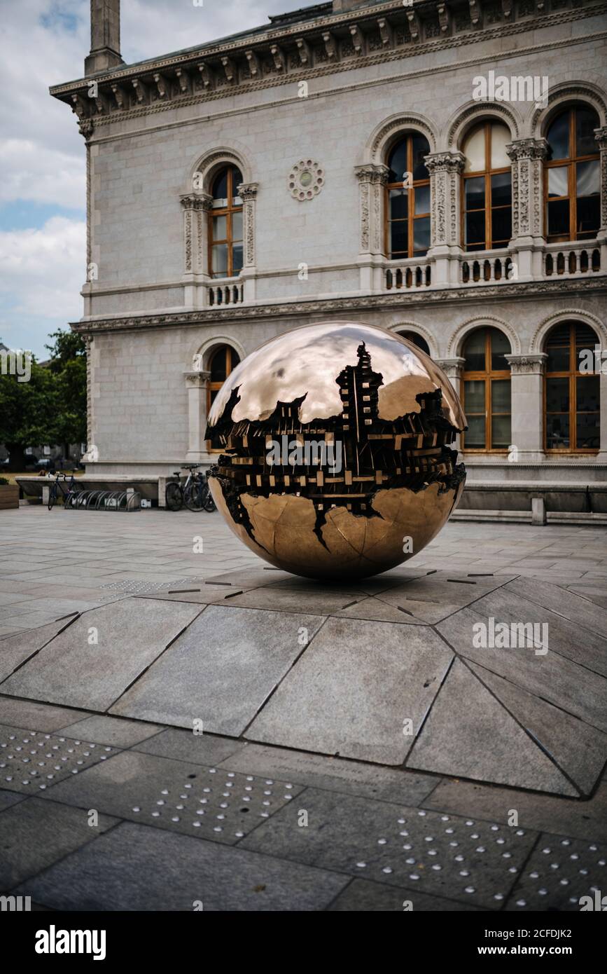 Sculpture 'Sphere Within Sphere' by Arnoldo Pomodoro on the grounds of Trinity College, Dublin, Ireland Stock Photo