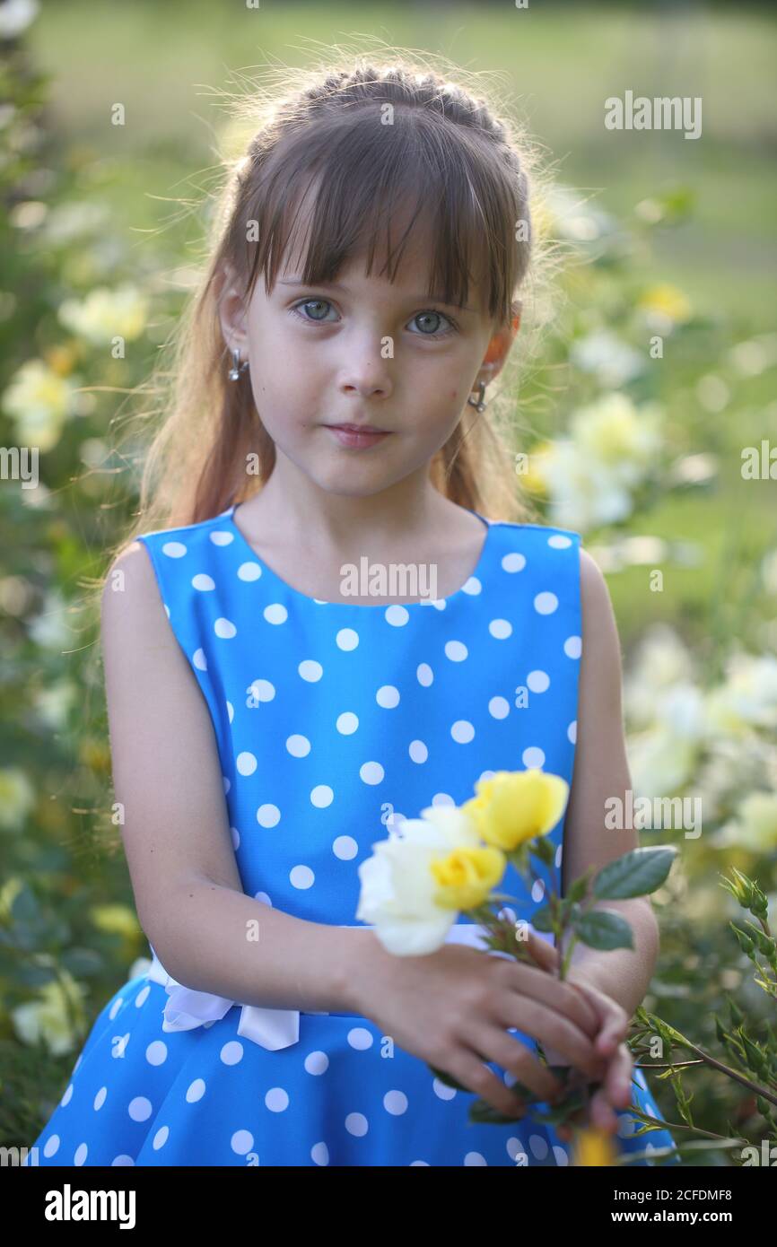 Girl near the flowers Stock Photo Alamy