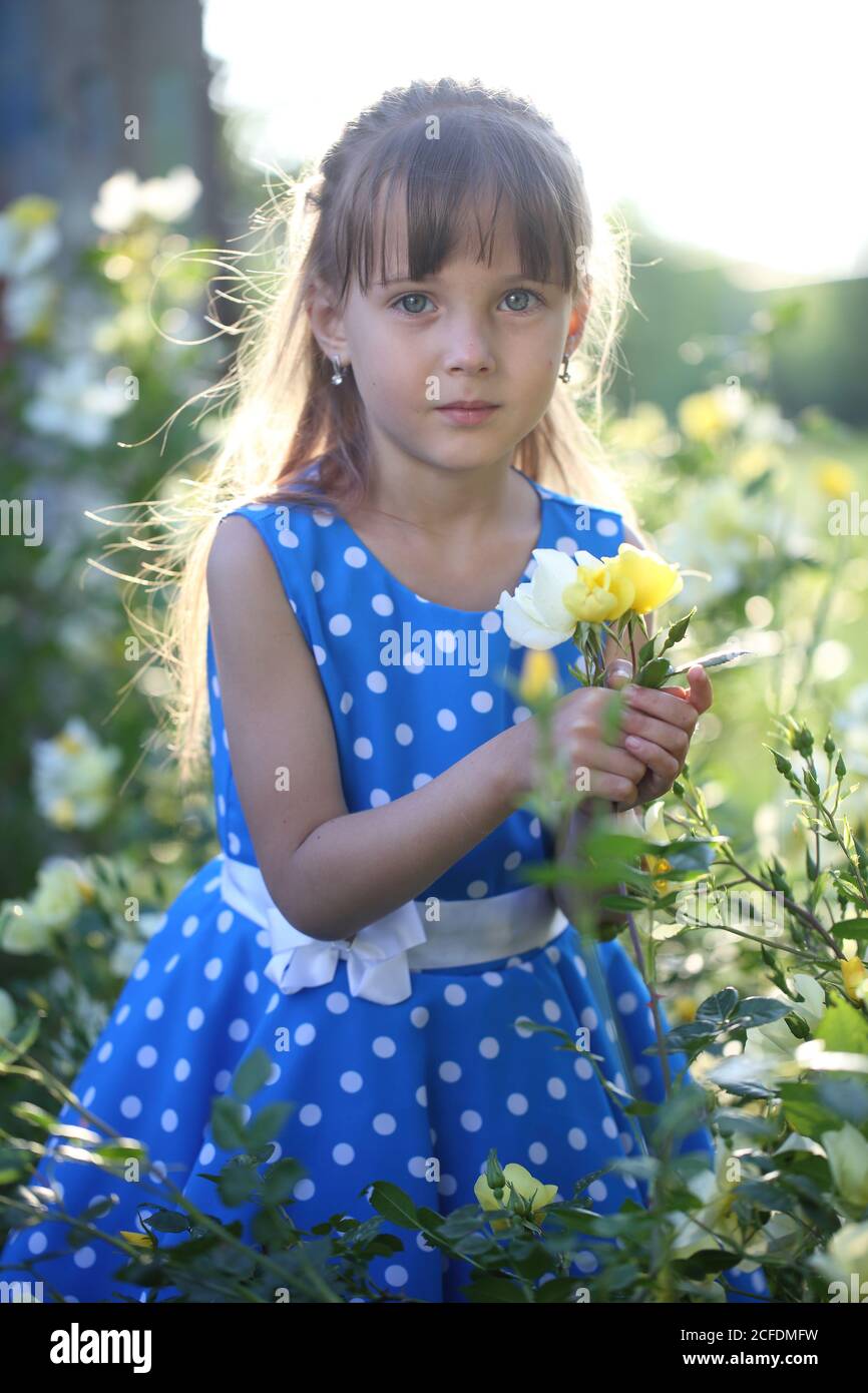 Girl near the flowers Stock Photo Alamy
