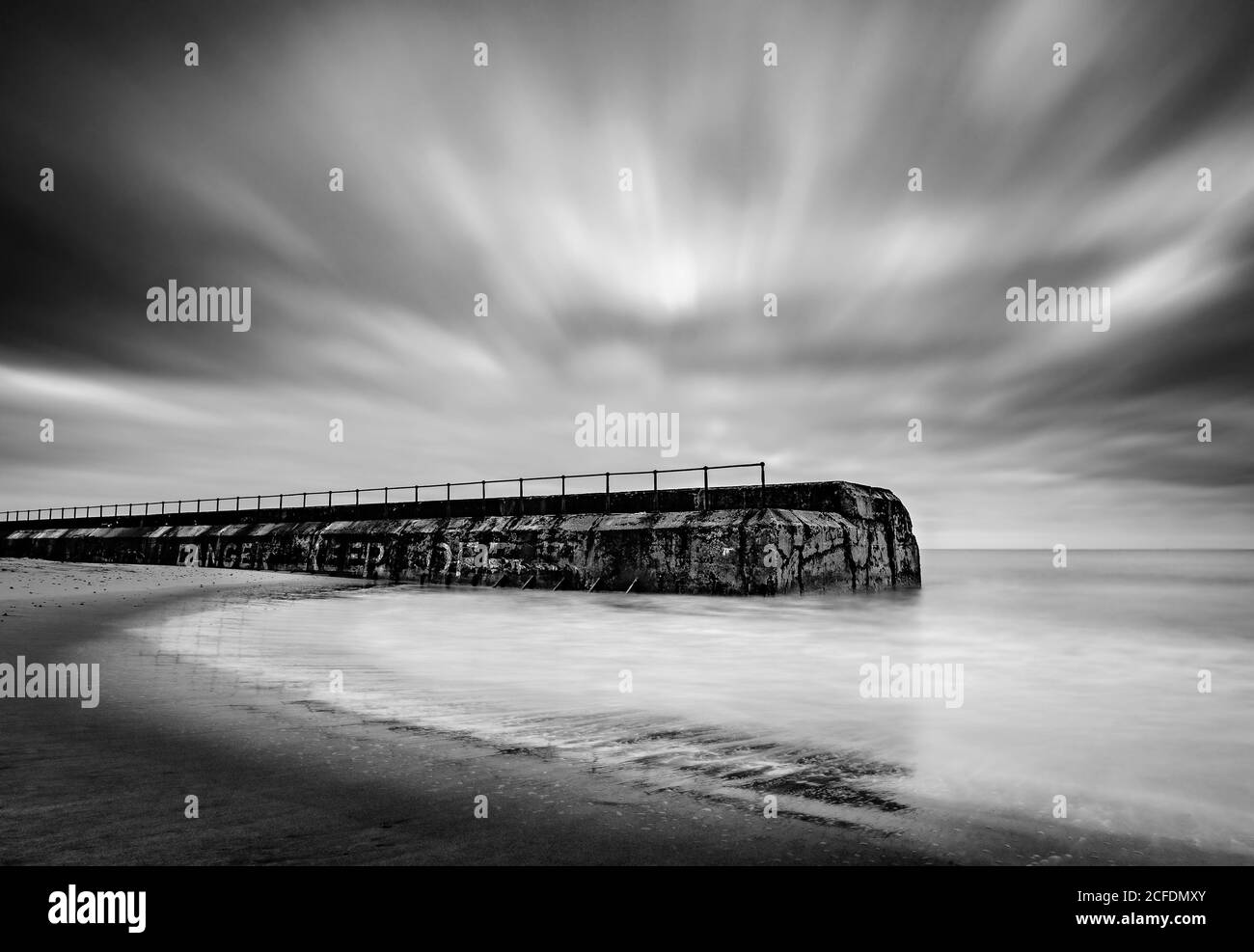 Disused stone jetty on Goleston beach Stock Photo - Alamy