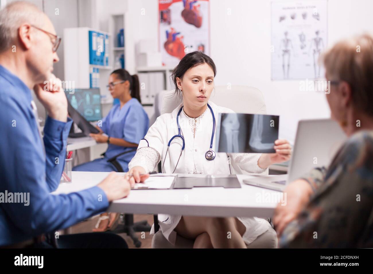 Doctor examining elderly man radiography during consultation in