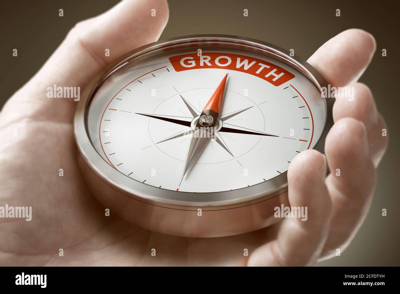 Man hand holding compass with needle pointing the word growth. Investment of financial concept. Composite image between a hand photography and a 3D ba Stock Photo