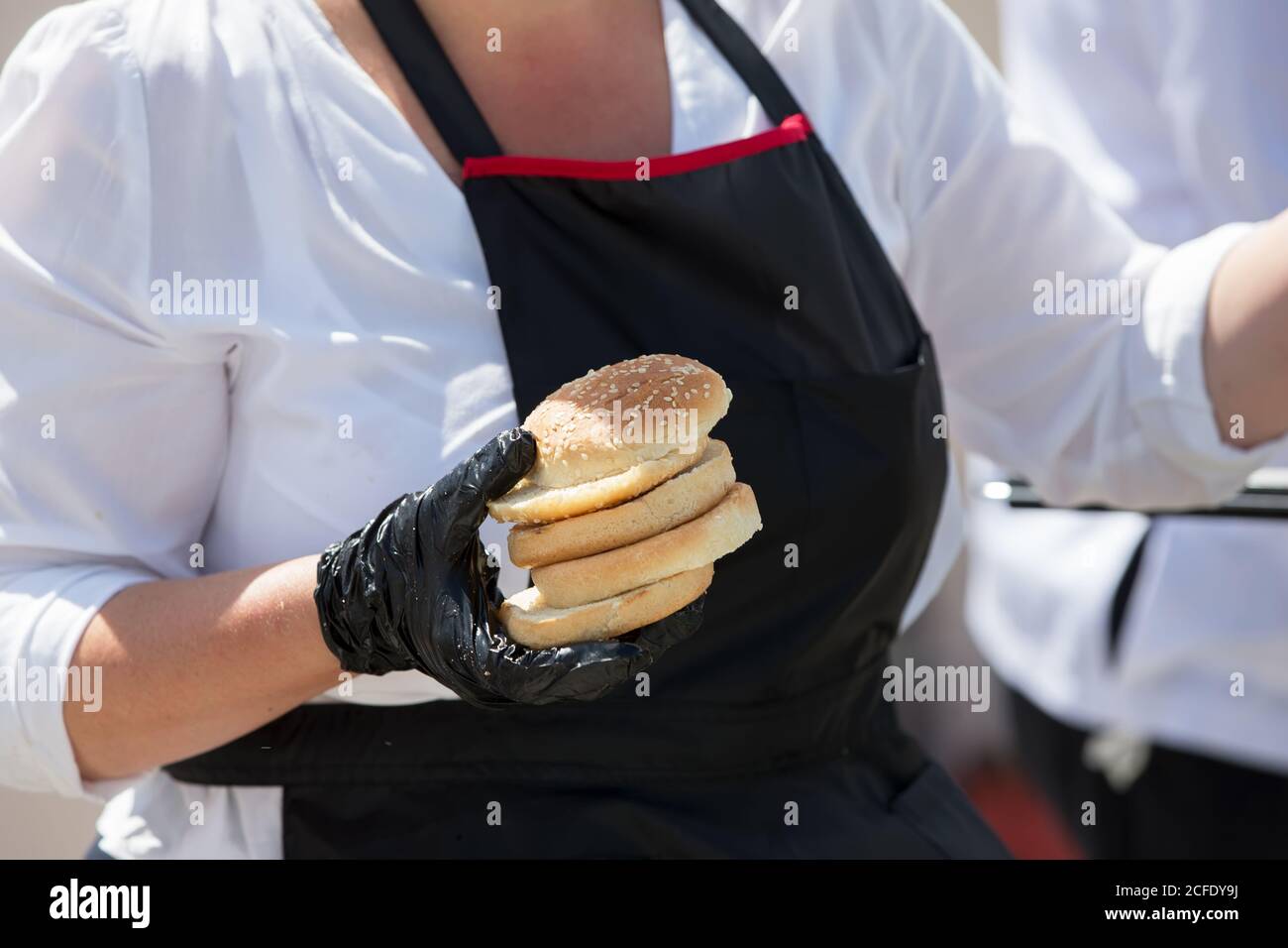 Hamburger buns in the hands of the chef Stock Photo Alamy