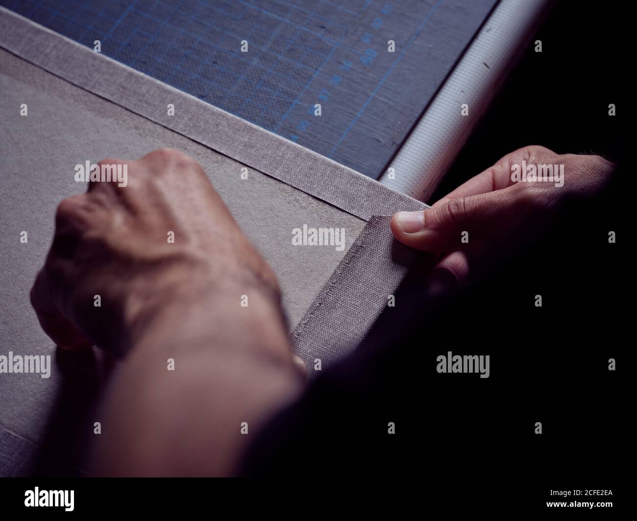 Bookmaker folding paper over cover board Stock Photo Alamy