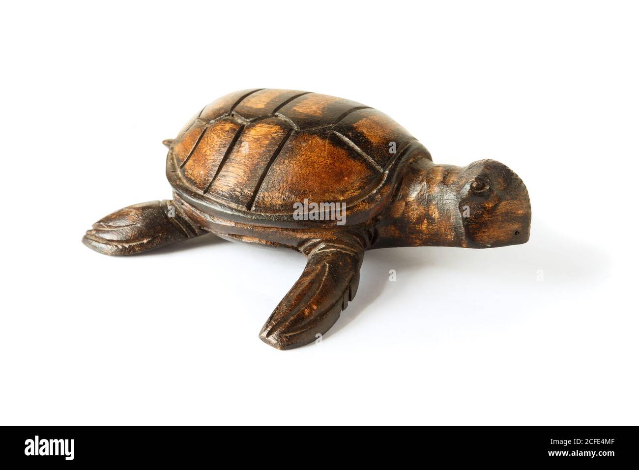 Wooden figurine of a sea turtle isolated on a white background. Stock Photo