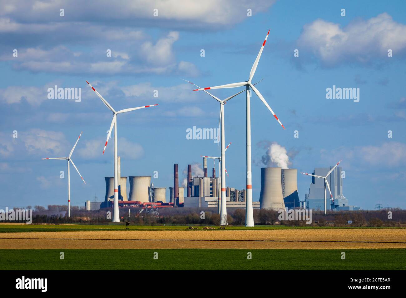 Wind wheels in the wind farm in front of RWE Neurath power station at the Garzweiler opencast mine, Grevenbroich, North Rhine-Westphalia, Germany Stock Photo